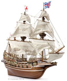 a wooden model ship with white sails and american flags on it's masts