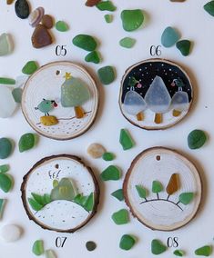 four pieces of wood with sea glass on them