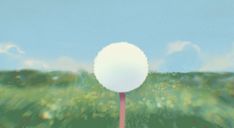 a blurry photo of a white ball on top of a stick in the middle of a field