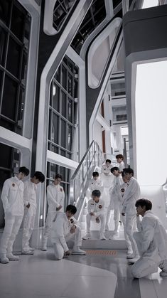 a group of young men standing next to each other on top of a white floor