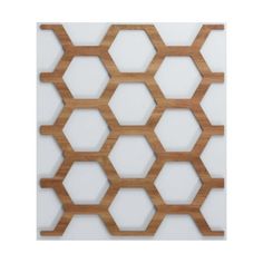 a wooden wall with hexagonals on it and white walls in the background