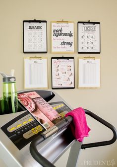 there are calendars hanging on the wall above a treadmill