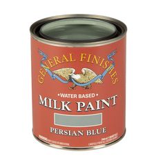 a can of water based milk paint with a spoon in it