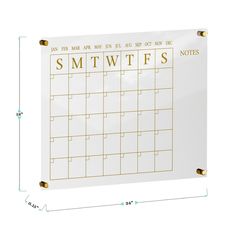 a white calendar with gold lettering on it