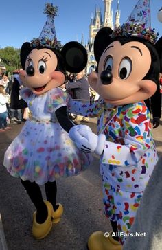 mickey and minnie mouse dancing in front of the castle at walt world's magic kingdom