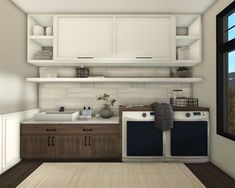 a white and brown kitchen with two washer dryers next to each other in front of a window