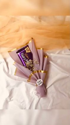 a bouquet of flowers sitting on top of a white sheet