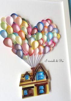 a card with a house and balloons in the shape of a heart on top of it