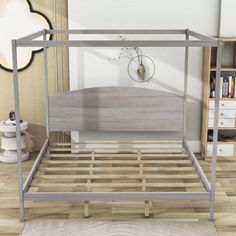 a metal bed frame in a bedroom with wooden floors