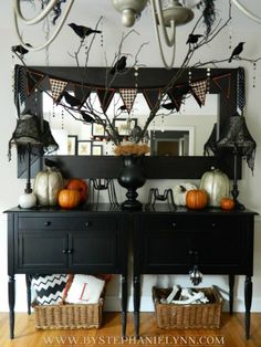 a black dresser topped with lots of halloween decorations