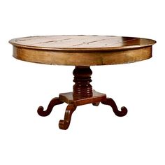 an oval wooden table with three legs