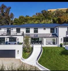 a large white house with stairs leading up to it