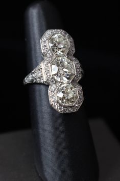 Edwardian Diamond Cocktail Ring with European Cut Diamonds | From a unique collection of vintage three-stone rings at https://www.1stdibs.com/jewelry/rings/three-stone-rings/ Vintage Diamond Rings Antique, Art Deco Three Stone Diamond Ring, Art Deco Three Stone Diamond White Ring, Art Deco Diamond Three Stone Ring, Diamond White Three Stone Art Deco Ring, Formal Art Deco Three-stone Diamond Ring, Art Deco Three Stone Ring For Formal Occasions, Platinum Three Stone Ring - Fine Jewelry, Platinum Three Stone Fine Jewelry Ring