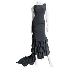 A fabulous black silk dress from an early collection of Alexander McQueen. It skims the body has a scoop neckline and 3 rows of ruffles beginning at knee level in the front and 8 starting at the derriere in the back cascading down through the train. The dress has a center back invisible zipper, is unlined and cut on on the bias for flexibility in fit. Fits sizes Extra Small, Small. Marked Italian size 42. Bust 36" Waist 32" Hips 36" Length 55-80" Dress With Ruffle Hem, Alexander Mcqueen Dresses, Alexander Mcqueen Fashion, Mcqueen Fashion, Black Silk Dress, Dress With Ruffles, Silk Maxi Dress, Long Sleeve Bodycon, Long Sleeve Bodycon Dress