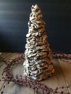 a paper mache christmas tree on a wooden table