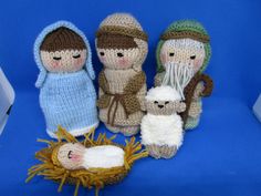 knitted nativity figurines are displayed on a blue background