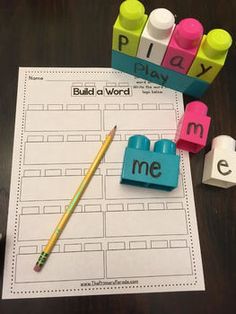 the word me is spelled out with markers and pencils next to it on a table