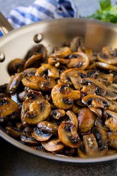 a pan filled with mushrooms sitting on top of a table