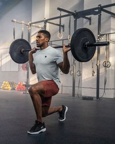 a man squats while holding a barbell