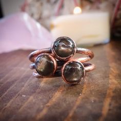 6mm black moonstone ring in copper. Set of 3 rings on a wood table Moonstone Rings, Electroformed Ring, Black Moonstone, Rustic Jewelry, Handcrafted Rings, Copper Rings, Blackbird, Moonstone Ring, Moon Stone