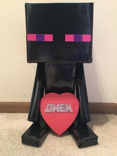 a black and pink robot holding a red heart