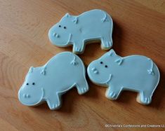 three decorated cookies shaped like elephants on a table