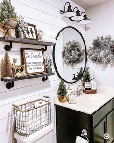 a bathroom decorated for christmas with wreaths and pine cones