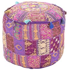 a colorful patchwork poufce with tassels on the top and bottom