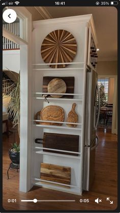 an open refrigerator with wooden cutting boards on it