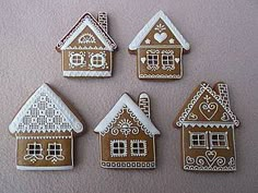 four decorated gingerbread houses sitting on top of a table