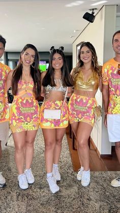 a group of people standing next to each other wearing costumes and posing for a photo