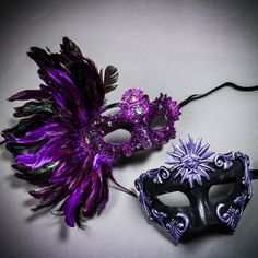 two masquerade masks with purple feathers on them