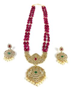 Long mala / haram set in traditional temple style locket with contemporary ruby pink beads. Beautiful pendant and earrings with pearls, CZs, emerald and ruby stones. Very high quality set with premium 24 micron gold plating. Pearl Mala, Earrings With Pearls, Indian Necklace, Big Pearl, Ivory Pearl, Cz Earrings, Purple Stones, Pink Beads, Semi Precious Stones