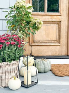 fall front porch decor with white pumpkins and flowers