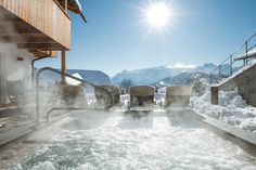 the hot tub is surrounded by chairs and snow