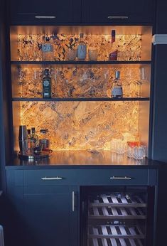 an open cabinet with bottles and glasses in it