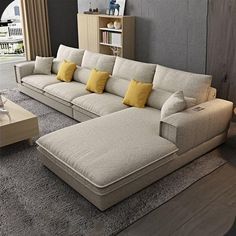 a living room filled with lots of furniture and pillows on top of carpeted flooring