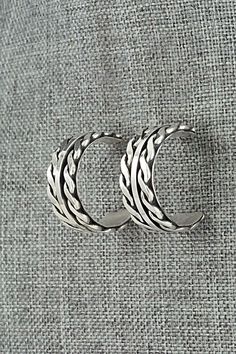 This pair of sterling silver hoop earrings were made by Navajo silversmith Tom Hawk. The backs are signed and stamped sterling.Length: 1"Width: 3/8"Free shipping on all orders! We ship with USPS and always include tracking. All orders ship within a day of payment.Returns are accepted up to 30 days after you receive your order. Just send us a message. Our shop offers cash back or store credit. The item must be returned in new condition. Silver Southwestern Hoop Earrings As Gift, Silver Southwestern Hoop Earrings For Gift, Southwestern Silver Round Hoop Earrings, Bear Carving, Sterling Silver Hoop Earrings, Sterling Silver Hoops, Pearl Chain, Native American Jewelry, Silver Hoops