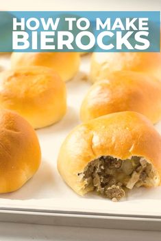 some bread rolls on a white tray with the words how to make bierocks