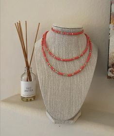 This bracelet and necklace duo is a beautiful coral pink with gold detail beads.  Necklace is 15 inches. Adjustable Coral Jewelry With Tiny Beads, Adjustable Single Strand Coral Beaded Necklace, Adjustable Coral Beaded Single Strand Necklace, Adjustable Coral Single Strand Beaded Necklace, Coral Necklaces With Gold Beads For Gifts, Adjustable Coral Beaded Necklace As A Gift, Coral Beaded Multi-strand Necklace, Coral Beaded Necklaces With Colorful Beads For Gifts, Adjustable Coral Necklace With Colorful Beads