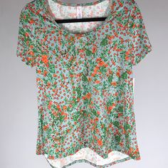 Lularoe Classic Tee - M - Floral Lularoe Classic Tee May Just Be The Most Basic, Easy-To-Wear Top In The Lularoe Collection. The Lularoe Classic T Has A Refined Silhouette With A Semi-Fitted Shape That Pairs Beautifully With Leggings And Skirts. It Also Looks Stunning Layered Over Many Of The Dresses In The Lularoe Collection. Spring Stretch Top With All Over Print, Green All-over Print T-shirt For Spring, Green All Over Print T-shirt For Spring, Stretch Top With All Over Print For Spring, Stretch Tops With All Over Print For Spring, Green T-shirt With All Over Print For Spring, Casual Printed Scoop Neck Tops, Spring Scoop Neck Printed Top, Spring Printed Top With Scoop Neck