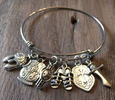 The Armor of God Bangle Charm Bracelet is made using a stainless steel bangle bracelet. It is non-tarnishing and hypo-allergenic. The charms are an antique silver color coated metal. It features the charms: Helmet of Salvation, Breastplate of Righteousness, Belt of Truth, Shoes of Peace, Shield of Faith and Sword of the Spirit. - It is a standard size and is slightly adjustable for ease in putting it on and taking it off. - It comes with a bookmark to use as a guide while praying through the Arm Adjustable Nickel-free Stainless Steel Bangle, Adjustable Stainless Steel Nickel-free Bangle, Stainless Steel Charm Bracelet Bangle, Stainless Steel Friendship Bangle, Adjustable Stainless Steel Charm Bracelets, Adjustable Stainless Steel Bangle Charm Bracelet, Stainless Steel Bangle Charm Bracelet, Adjustable Stainless Steel Bracelets With Charms, Nickel-free Metal Bangle Charm Bracelet