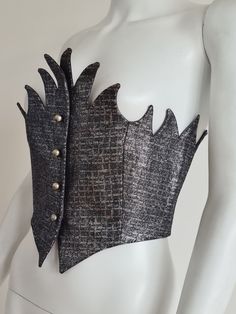 Romeo Gigli Fall/Winter 1992, runway model. Bustier in a kind of lamé fabric covered with small hexagonal pastilles, four jingly bell buttons at the front, fully lined in grey satin. This exceptional model is in the collection of the Metropolitan Museum in New York, to which it was donated by the writer  and New York Times style editor Holly Brubach. Rare piece, probably a runway show or press shoot piece. Fabric tag: cotton, synthetic fibers. Size tag: 42 IT Width at the top : 43 cm Width at th Lamé Fabric, Lame Fabric, Romeo Gigli, Runway Model, New York Museums, Metal Clothing, Corset Bustier, Fabric Tags, Bustiers