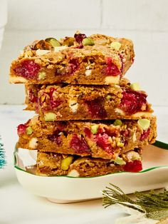 a stack of granola bars sitting on top of a white plate next to a christmas tree