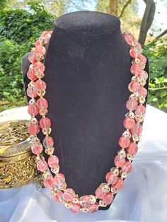 This is such a pretty pinkish double stranded beaded necklace. I don't see any damage, just normal aged patina around clasp. Approx 10 inches long fully clasped. Signed Hong Kong https://www.etsy.com/shop/VintageByTerri Please remember that these items are previously loved items...which is part of their charm. They all have their own story to tell. I try to describe any flaws I see but I also am not perfect, so please look at the photos carefully. I do NOT clean my Jewelry items as I am afraid t Formal Double Strand Beaded Necklaces, Formal Double Strand Beaded Necklace, Vintage Pink Beaded Necklace With Round Beads, Vintage Handmade Double Strand Beaded Necklace, Pink Vintage Beaded Necklaces With Colorful Beads, Vintage Multi-strand Beaded Chain Necklaces, Pink Beaded Double Strand Jewelry, Pink Double Strand Beaded Jewelry, Double Strand Faceted Beads Costume Jewelry Necklace