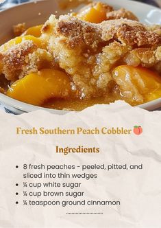 a bowl filled with peach cobbler ingredients on top of a table