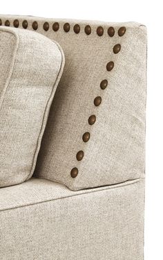 an upholstered couch with buttons on it