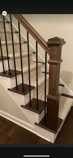 an image of a stair case with wood and metal handrails on the bottom