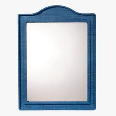 a blue mirror sitting on top of a white wall