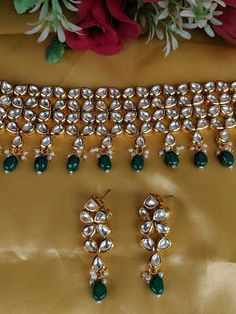 Adorn your beautiful personality with this exquisitely designed and handcrafted high quality kundan choker necklace and earrings set . Pair it up with your silks and satins and shine like a glowing star at the next event! Necklace weight 120 GM's Length of the metal part 7 inches with an adjustable zari thread at the back Width from top to bottom 2.5 inches Earrings length 2.2 inches Weight 24 GM's Colour:Emerald Green Product Care: Avoid spraying perfume or deodorant over Traditional jewelry. E Festive Kundan Necklace As Gift, Festive Kundan Necklace For Gift, Kundan Necklace Hand Set As Gift, Emerald Kundan Necklace For Gift, Festive Kundan Hand Set Choker, Festive Kundan Choker With Hand Set Details, Kundan Choker Hand Set For Diwali, Heavy Lehenga For Festive Gift Occasion, Heavy Lehenga As Festive Gift